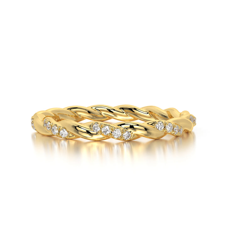 Detailed view of a twisted braided diamond ring crafted in 18K yellow gold, featuring brilliant-cut diamonds with F-G color and VVS-VS clarity. Angled photo showcasing the sculptural swirl pattern and approximately 0.85 carats of diamonds that flow seamlessly along the band.
