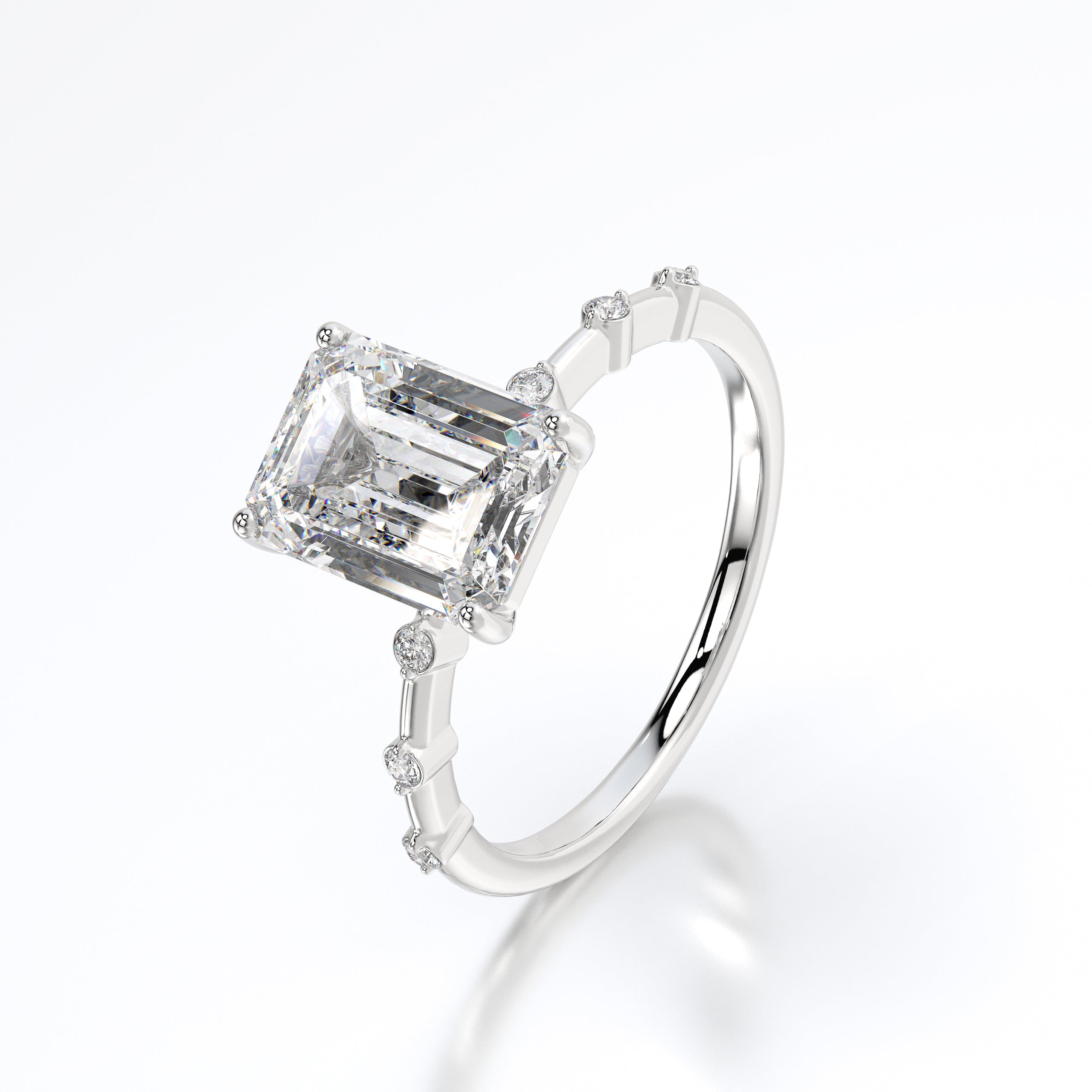 Overhead view highlighting the symmetry and clean facets of the emerald solitaire and the 0.45 carats of sparkling accents.